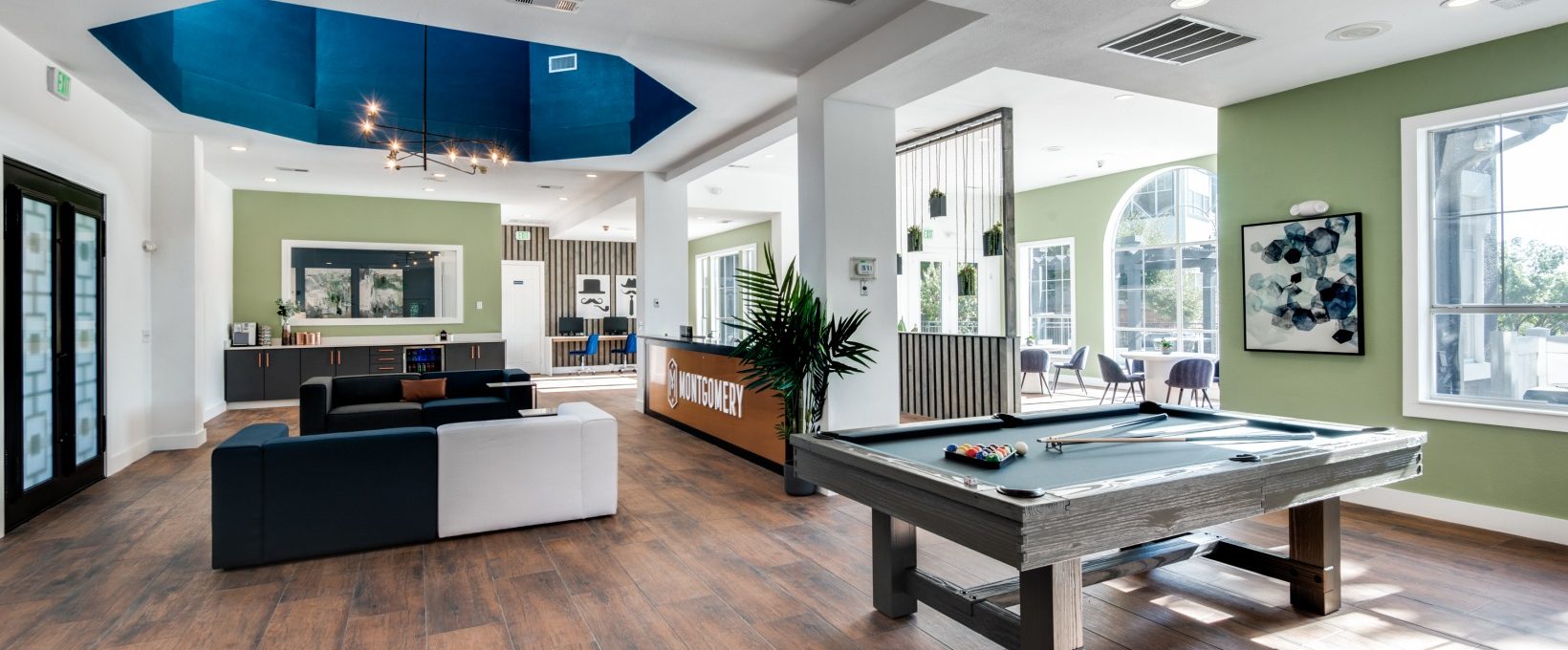 pool table in a living room with a blue ceiling at The  Montgomery