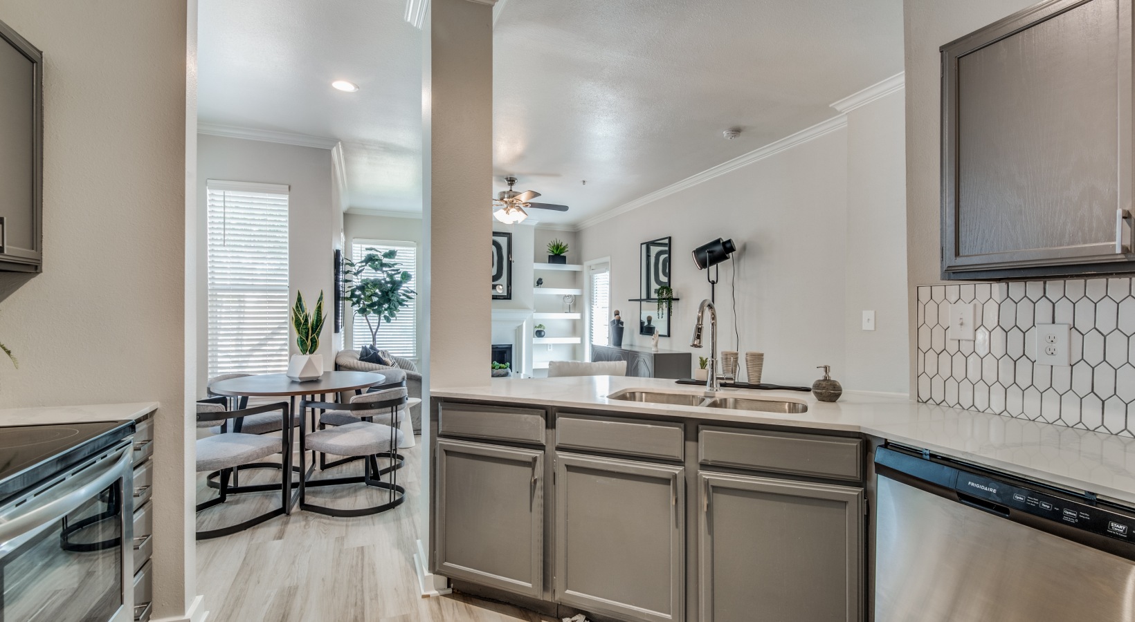 a kitchen with stainless steel appliances and gray cabinets at The  Montgomery