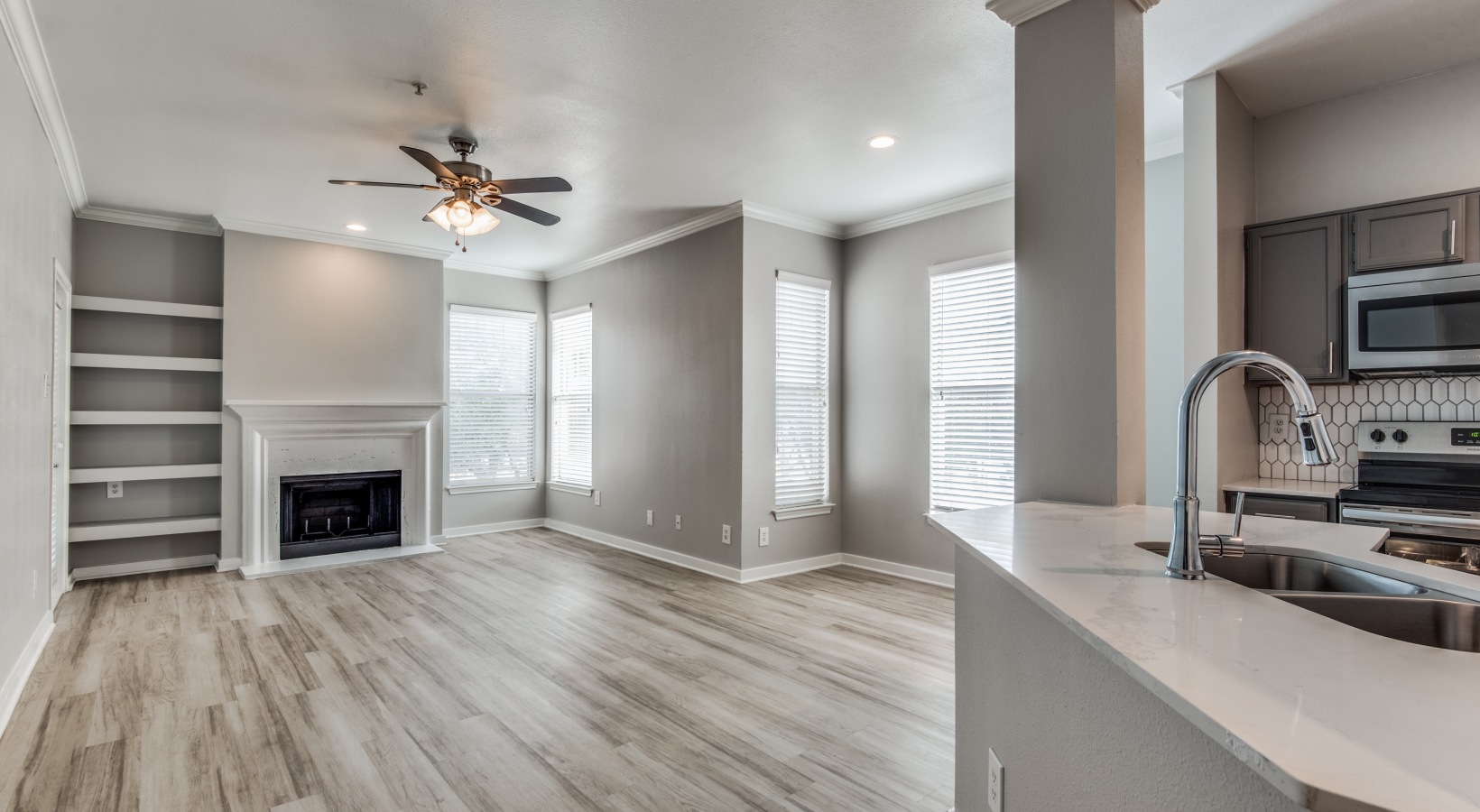 a clean and empty living room with hardwood floors at The  Montgomery